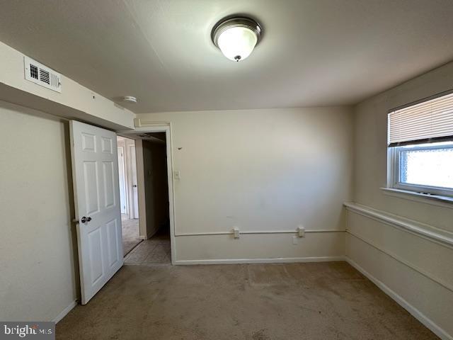 spare room with light colored carpet