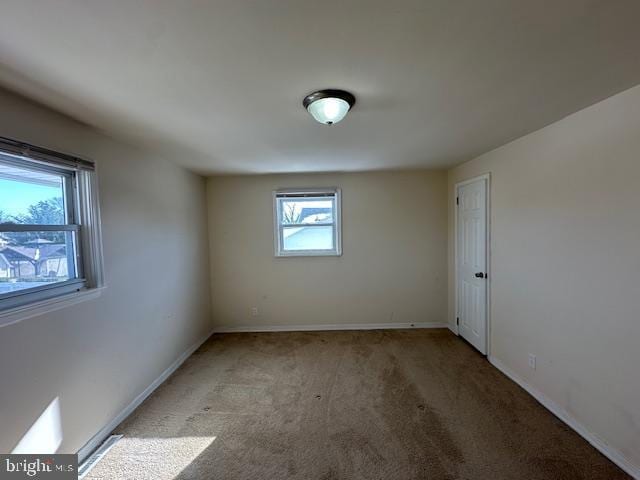 spare room with light colored carpet