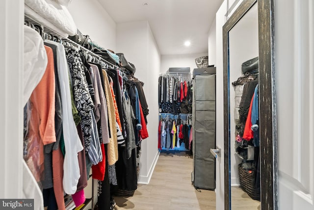 walk in closet featuring light hardwood / wood-style floors