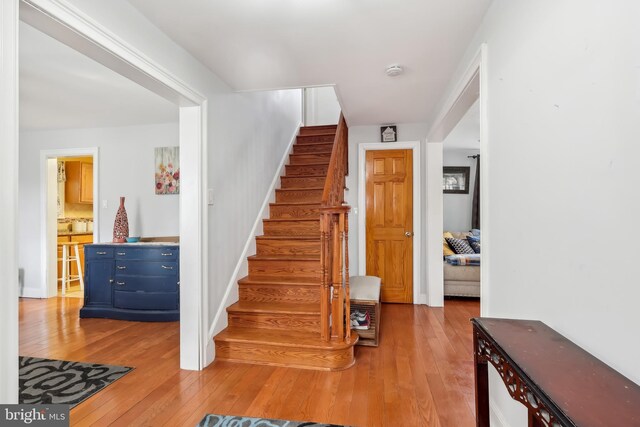 stairway with hardwood / wood-style flooring