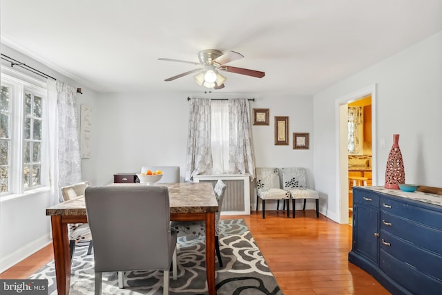 dining space featuring plenty of natural light, light wood-style flooring, baseboards, and ceiling fan