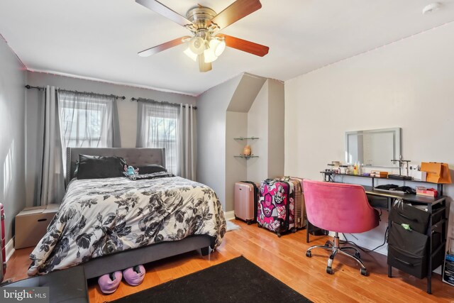 bedroom with ceiling fan and wood finished floors