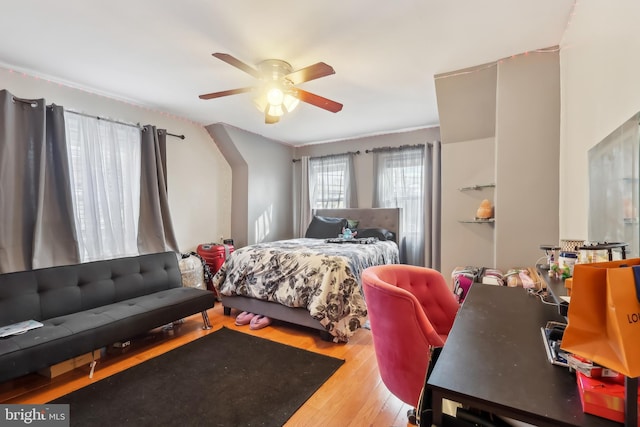 bedroom with a ceiling fan and wood finished floors