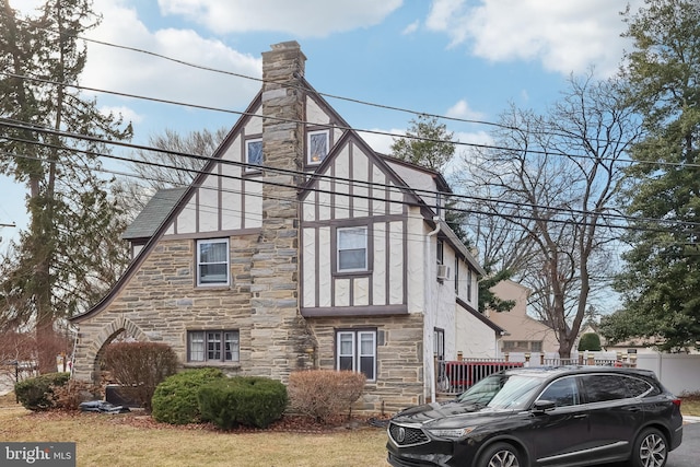 view of front of house with a chimney and stucco siding