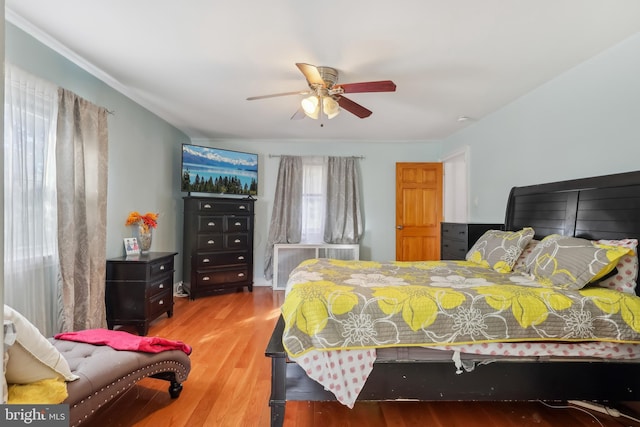 bedroom featuring a ceiling fan and wood finished floors