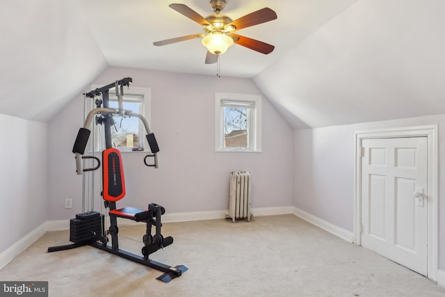 exercise room with lofted ceiling, carpet floors, radiator heating unit, and baseboards