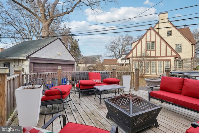 wooden terrace with an outdoor living space with a fire pit, an outdoor structure, and fence