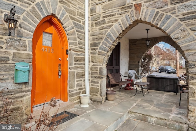 doorway to property with stone siding