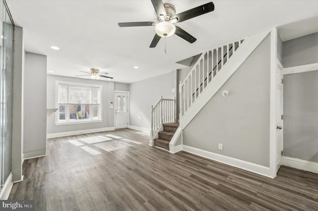 unfurnished living room with dark wood-type flooring