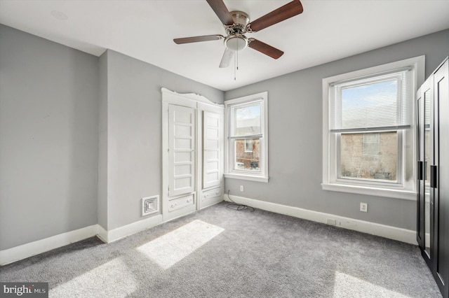 unfurnished bedroom with light colored carpet and ceiling fan