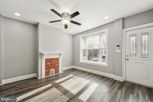 unfurnished living room featuring ceiling fan and dark hardwood / wood-style floors