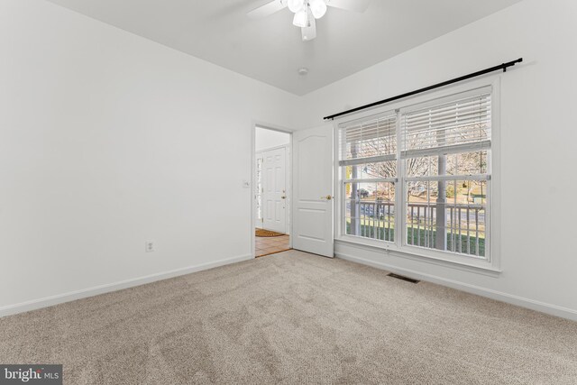 carpeted empty room featuring ceiling fan