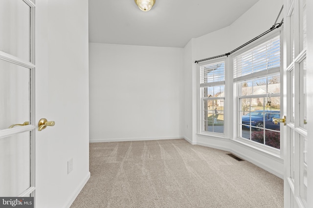 spare room with light colored carpet