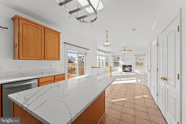 kitchen with a center island, hanging light fixtures, light tile patterned floors, dishwasher, and ceiling fan