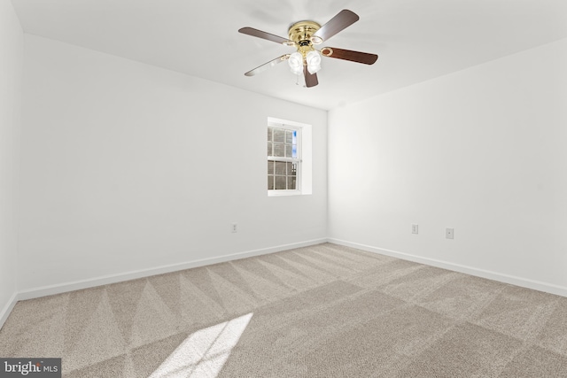 spare room featuring ceiling fan and carpet flooring