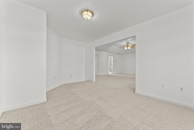 unfurnished room featuring light colored carpet and ceiling fan