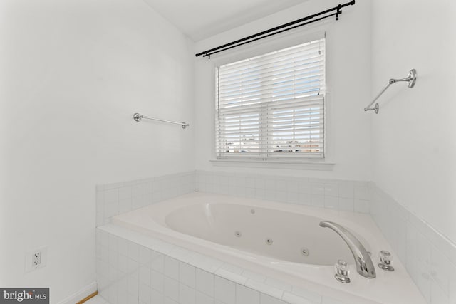 bathroom featuring tiled tub