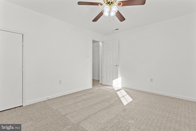 carpeted empty room featuring ceiling fan