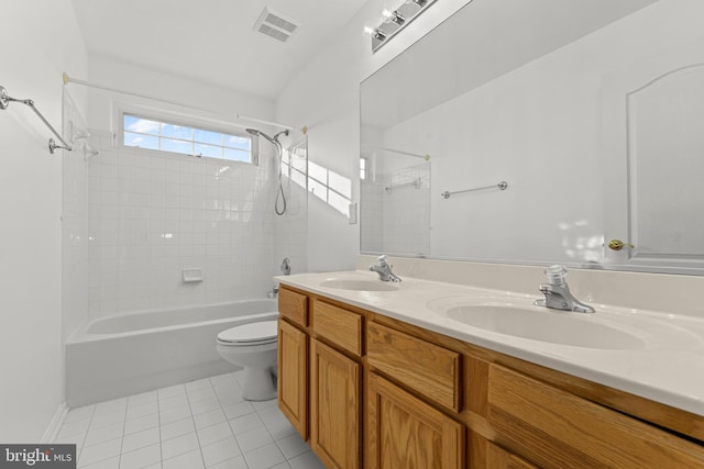 full bathroom with vanity, tiled shower / bath, tile patterned floors, and toilet