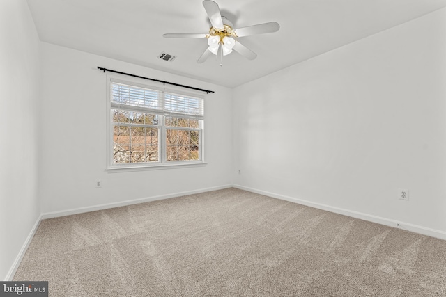 carpeted empty room featuring ceiling fan