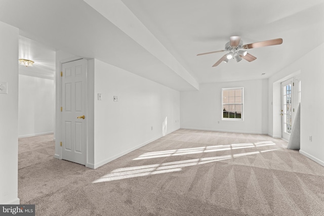 unfurnished living room featuring ceiling fan and light carpet