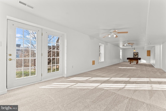 unfurnished living room with ceiling fan, light colored carpet, and pool table