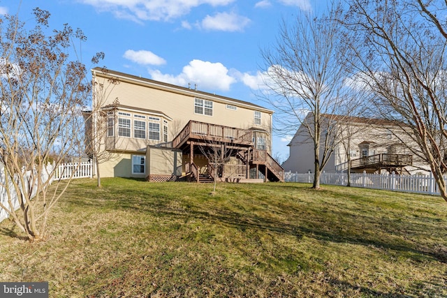 rear view of house with a deck and a lawn