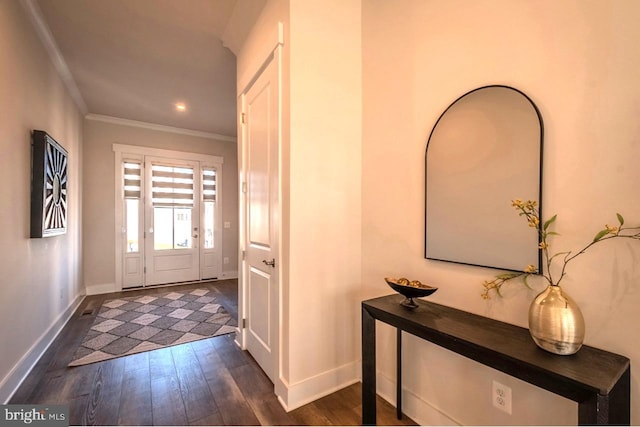 foyer with dark hardwood / wood-style flooring and crown molding