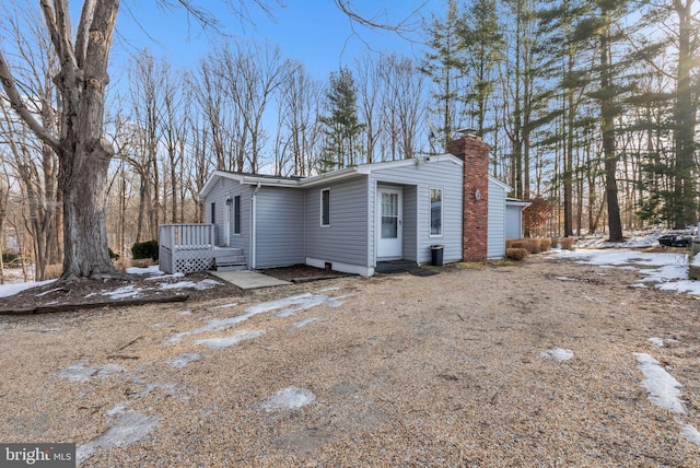 view of snowy exterior with a wooden deck