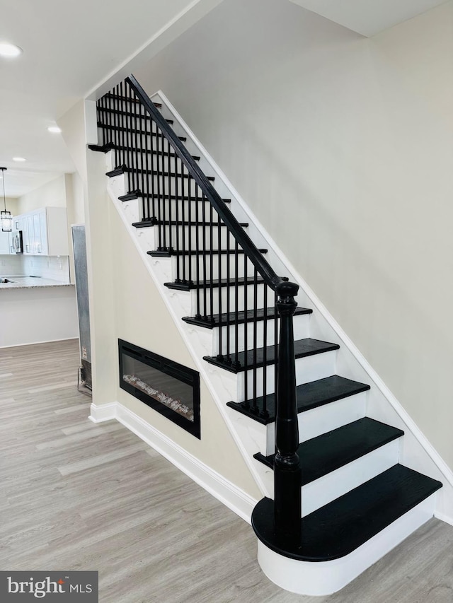 stairs with wood-type flooring