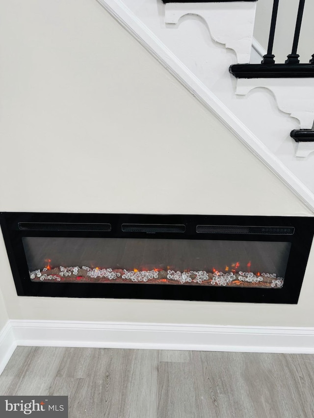 details with a fireplace and wood-type flooring