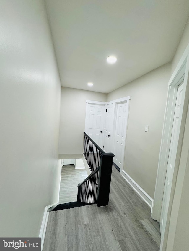 stairs featuring hardwood / wood-style floors