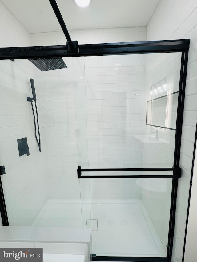 bathroom with a shower with door