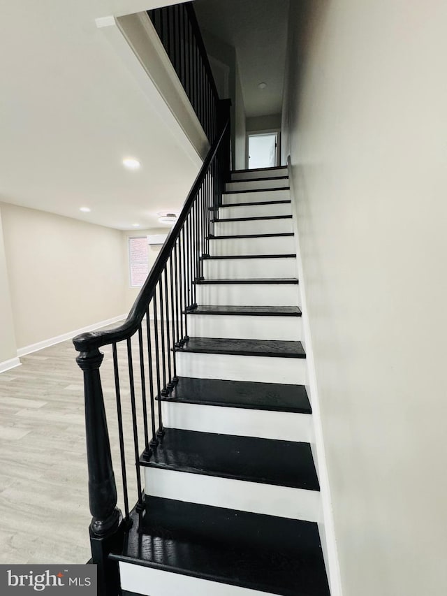 stairs featuring hardwood / wood-style floors