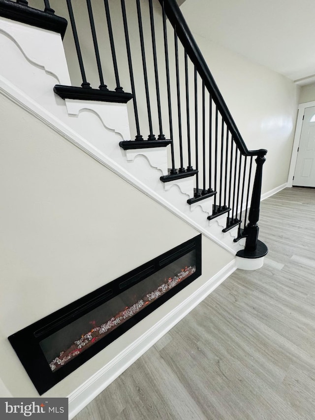 stairs featuring hardwood / wood-style floors