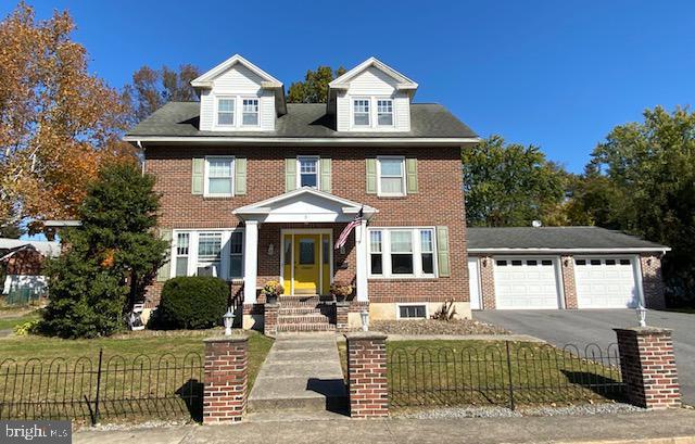 view of front of property with a garage and a front lawn