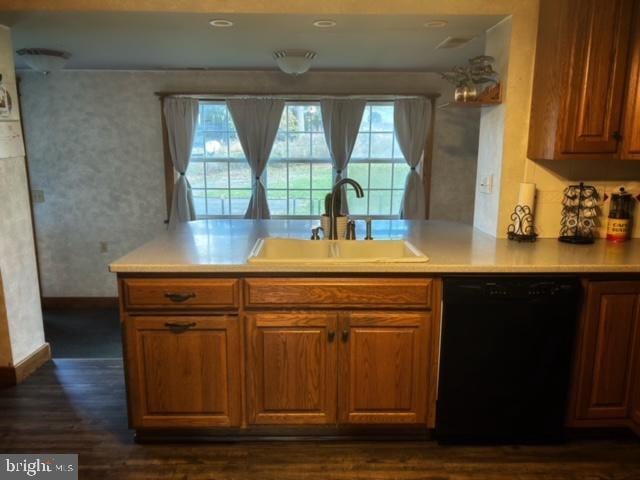 kitchen with dishwasher, sink, and dark wood-type flooring