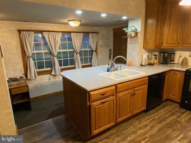 kitchen featuring black dishwasher, sink, dark hardwood / wood-style floors, and kitchen peninsula