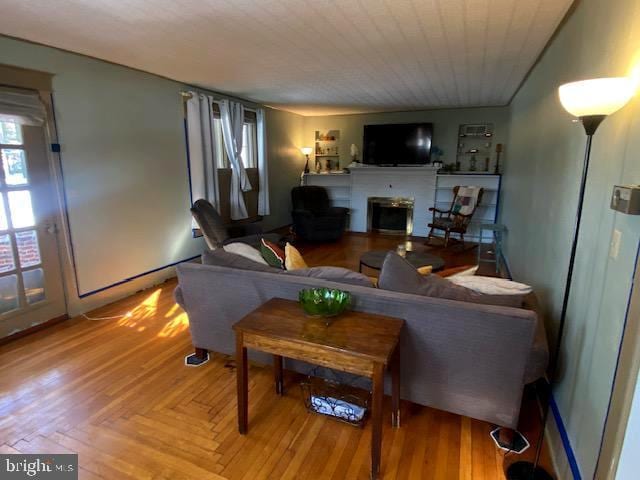 living room featuring parquet flooring and a fireplace