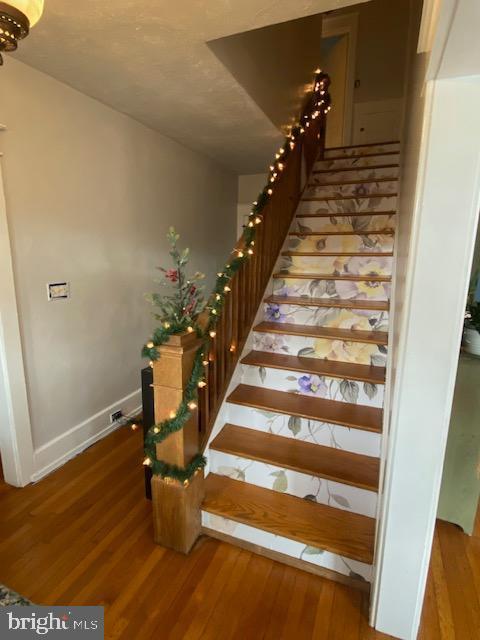 staircase featuring hardwood / wood-style floors