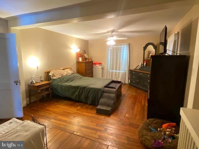 bedroom featuring ceiling fan and dark hardwood / wood-style floors