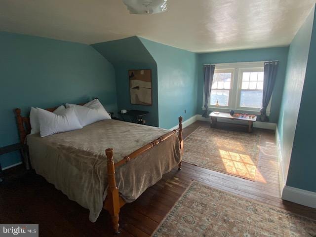 bedroom with dark wood-type flooring