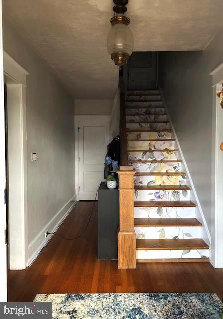 staircase with wood-type flooring