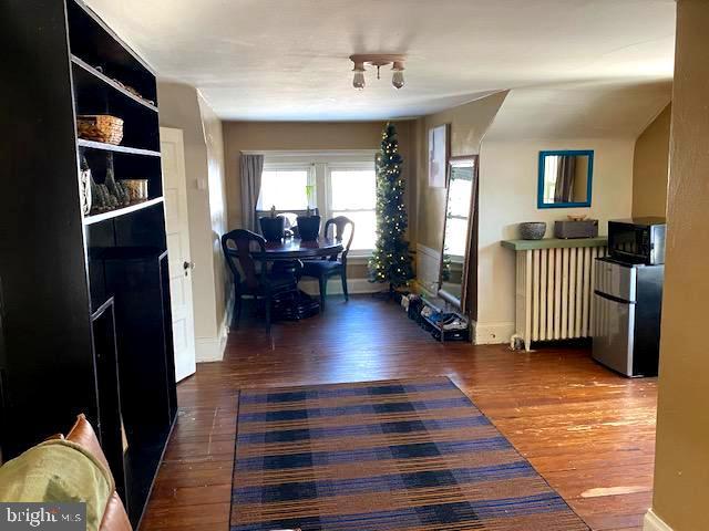 interior space with radiator and dark hardwood / wood-style floors