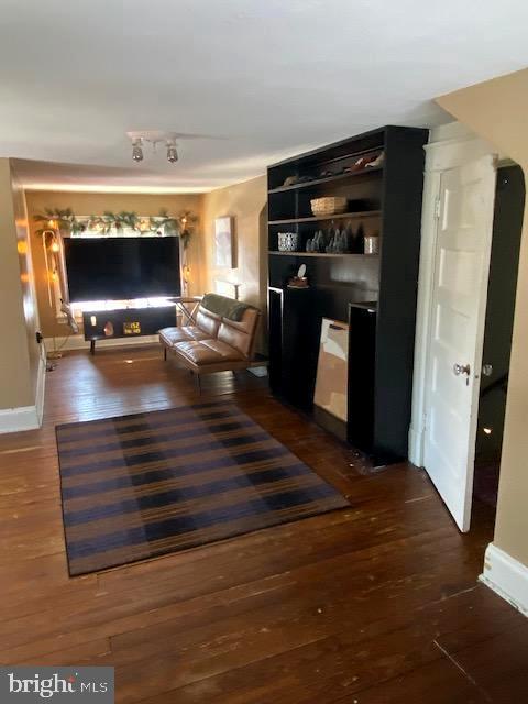 unfurnished living room featuring dark hardwood / wood-style floors