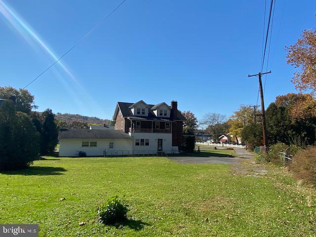 rear view of house featuring a lawn