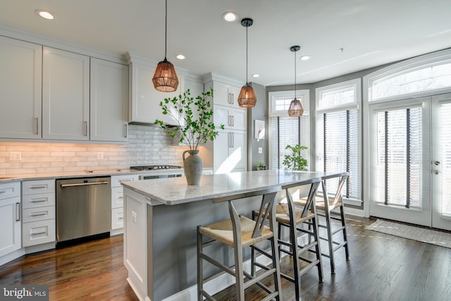 kitchen with white cabinetry, dishwasher, and a kitchen island