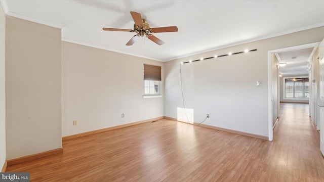 unfurnished room featuring baseboards, light wood-type flooring, a ceiling fan, and ornamental molding