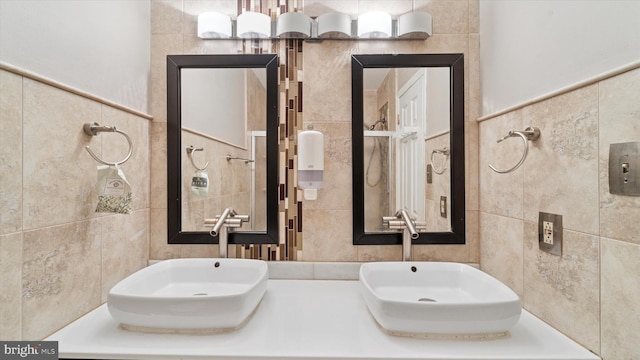 bathroom with tile walls and a sink