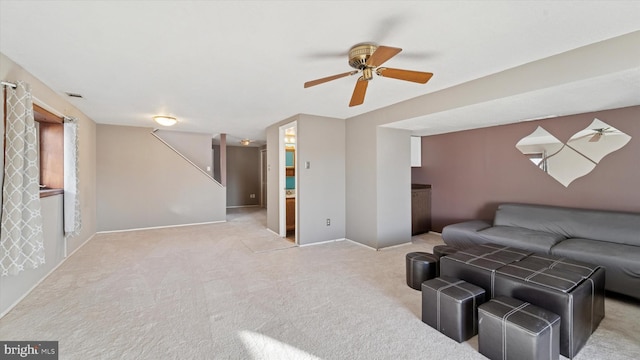 living room featuring stairs, carpet, and ceiling fan